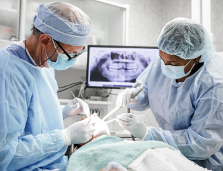 dr. seale and dental assistant working with a patient