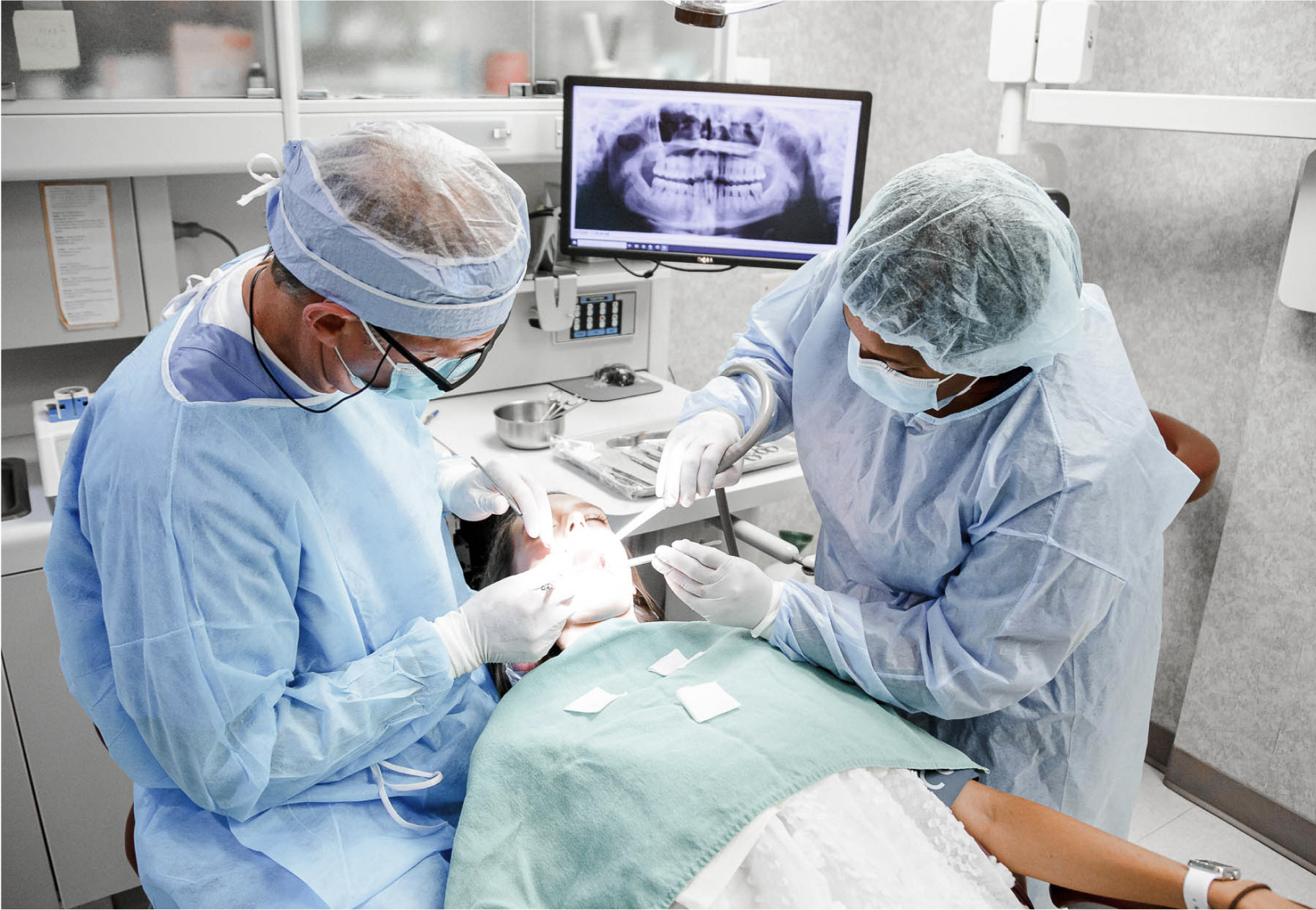 dr. seale and assistant performing a procedure on a patient