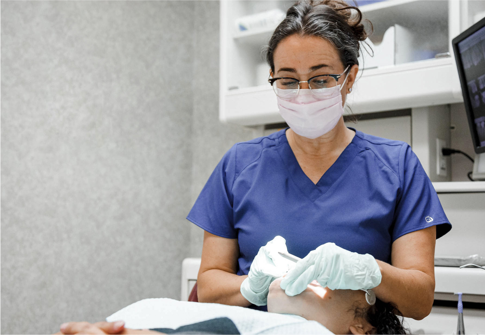dental assistant working with a patient