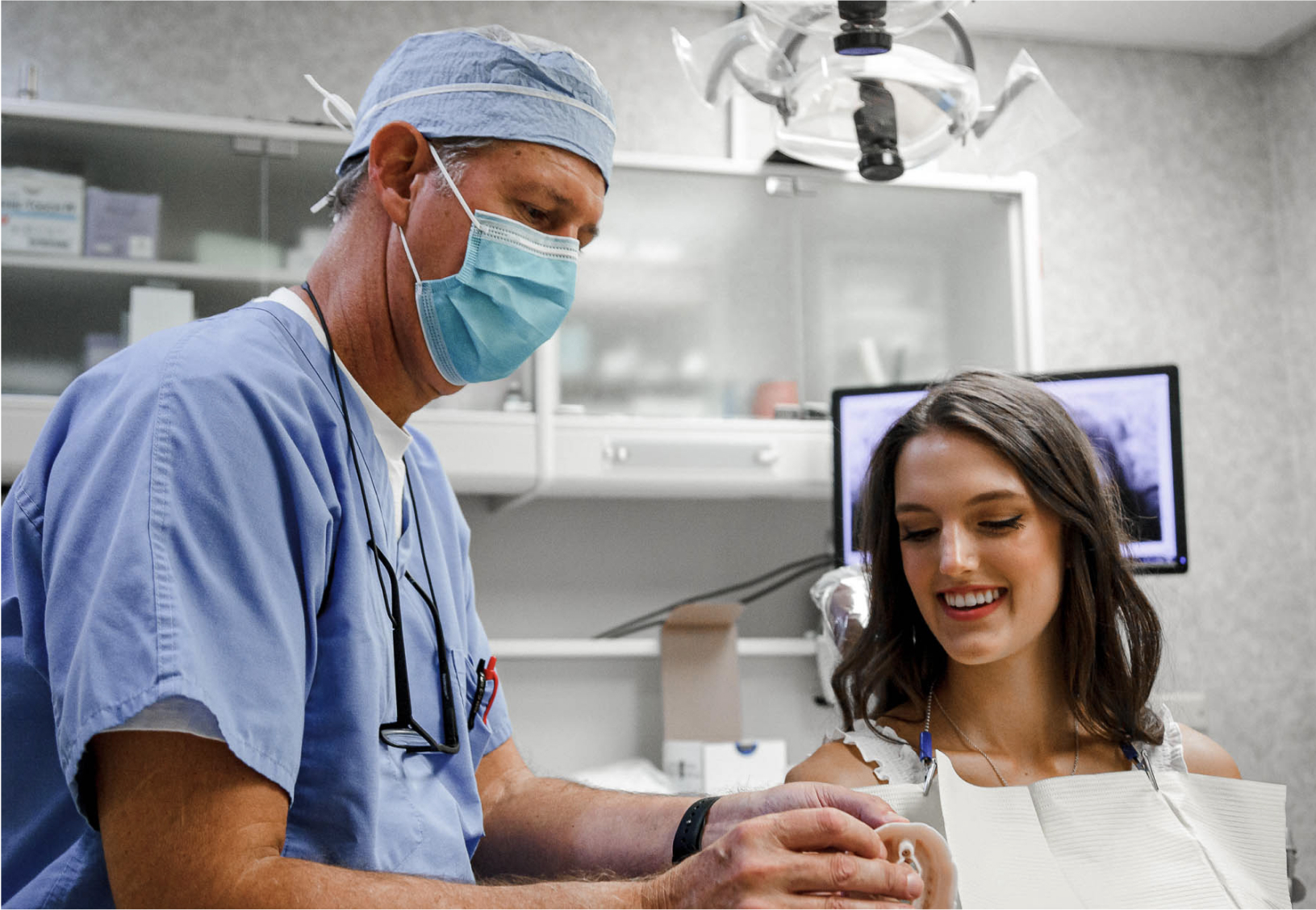 dr. seale showing patient a teeth model