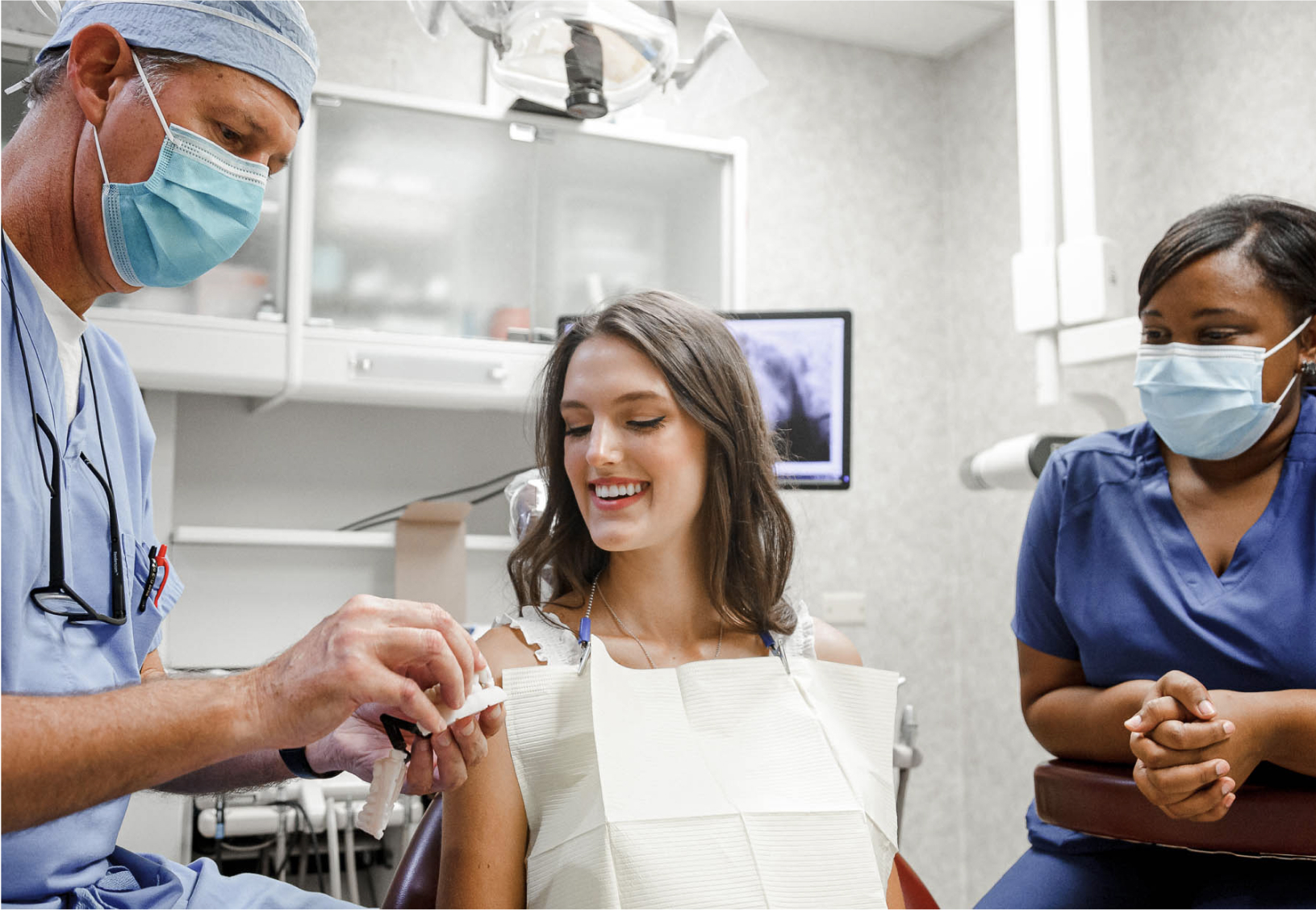 Dr. Seale showing a patient a teeth model